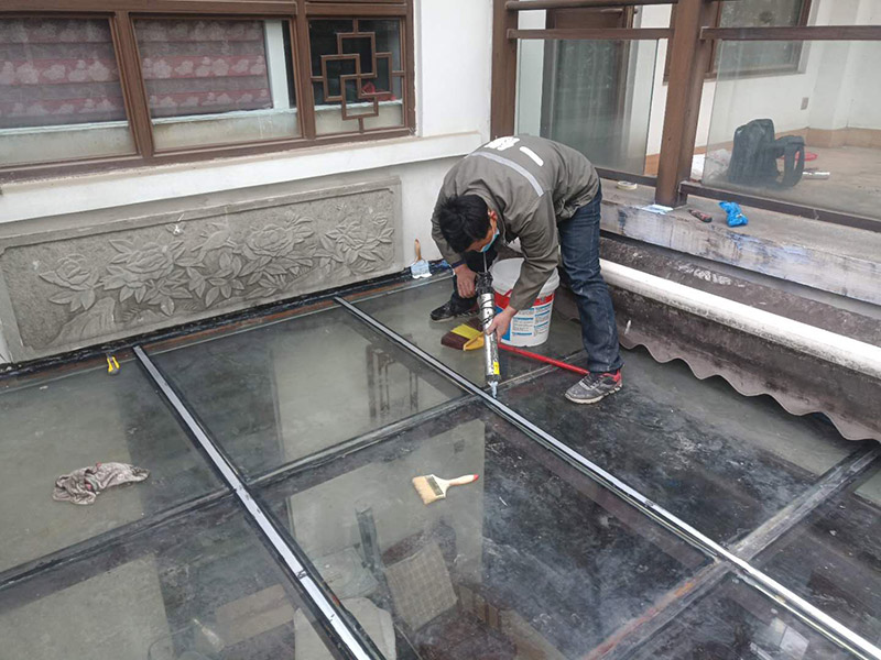 玻璃屋頂打膠防水：把陽(yáng)光房的邊清理干凈。用結(jié)構(gòu)膠往縫里填到60%。然后用和縫大小的泡抹棒往里壓填充，把膠往陽(yáng)光房與型材的縫里擠。最后填充耐候密封膠，用刮刀來(lái)回30度角度刮2遍。缺膠的補(bǔ)上。30分內(nèi)把紙揭掉。陽(yáng)光房的鋁合金、鋼材等框架材料連接處基本靠打建筑膠來(lái)固定與防漏水。建筑膠打膠前，需要將打膠處用溫布擦干凈且干了之后打膠，否則就算是用了高級(jí)的建筑膠，其實(shí)際效果只有普通建筑膠的效果，將會(huì)大大降低陽(yáng)光房結(jié)構(gòu)膠的使用壽命。