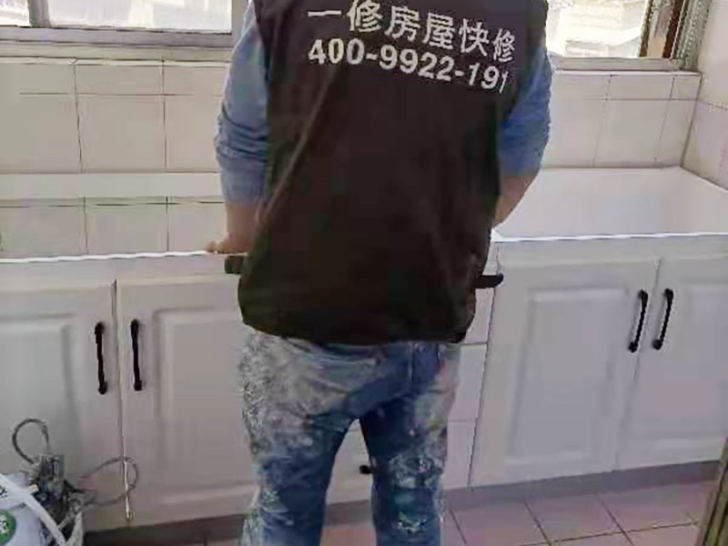 舊櫥柜更換安裝：櫥柜安裝一般先從地柜開始。把櫥柜外包裝拆開后。在櫥柜的邊緣貼上防火膜封邊。在下柜底部安裝上支腳，根據(jù)地面水平高度調(diào)整櫥柜。 櫥柜安裝需要找出基準(zhǔn)點(diǎn)，L型廚房從直角處向兩邊延伸，U型廚房則先將中間的一字型柜體放整齊后，再從兩個(gè)直角處向兩邊站看，這樣可以避免出現(xiàn)縫隙。 櫥柜框架安裝牢固定位后，需要在櫥柜背面。一般安裝下水都會現(xiàn)場開孔，工人會用專業(yè)的打孔器按照管道大小進(jìn)行打孔，打孔的直徑應(yīng)比管道大3-4毫米，并且打孔后要將開孔部分用密封條封邊，防止邊緣滲水木材變形。把打好孔的背板根據(jù)櫥柜位置，依次封裝進(jìn)去。接下去就是安裝吊柜了。同下柜一樣，吊柜也需要根據(jù)需要現(xiàn)場打孔，比如脫排油煙機(jī)的排煙管的孔位。
