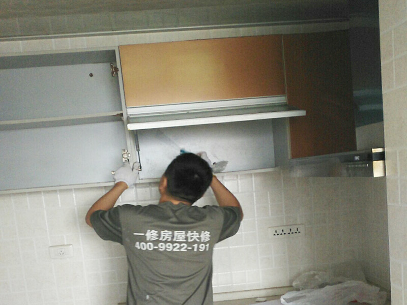  在安裝廚房吊柜之前，師傅要先用量尺確定了吊柜安裝的位置，確定好吊柜預(yù)定的位置，然后在墻面上鉆孔，便于塞入膨脹螺絲，安裝時(shí)先將拉桿裝入對(duì)應(yīng)安裝孔，然后將板塊連接，將吊柜提到吊片上，用工具扭緊螺絲釘固定。